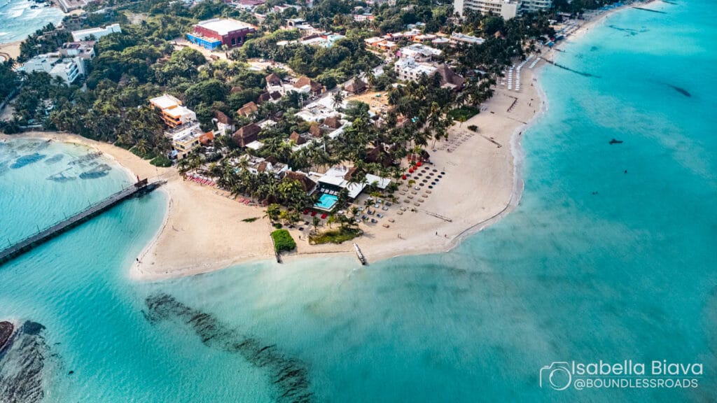 Aerial view of tropical beach and resort area.