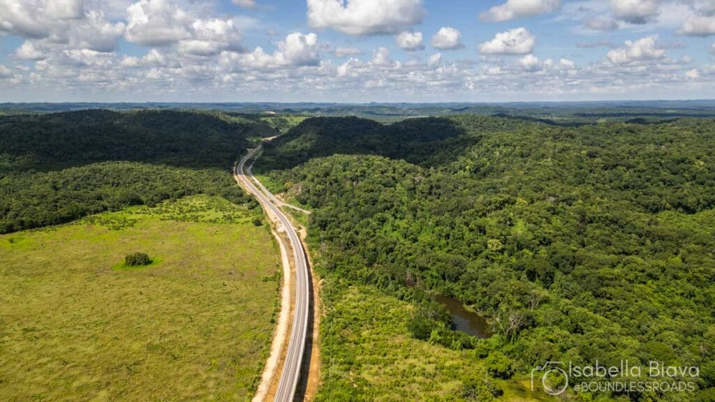 Aerial view of a winding road through forest