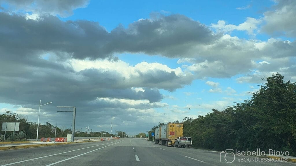 Open highway with parked trucks and cloudy sky