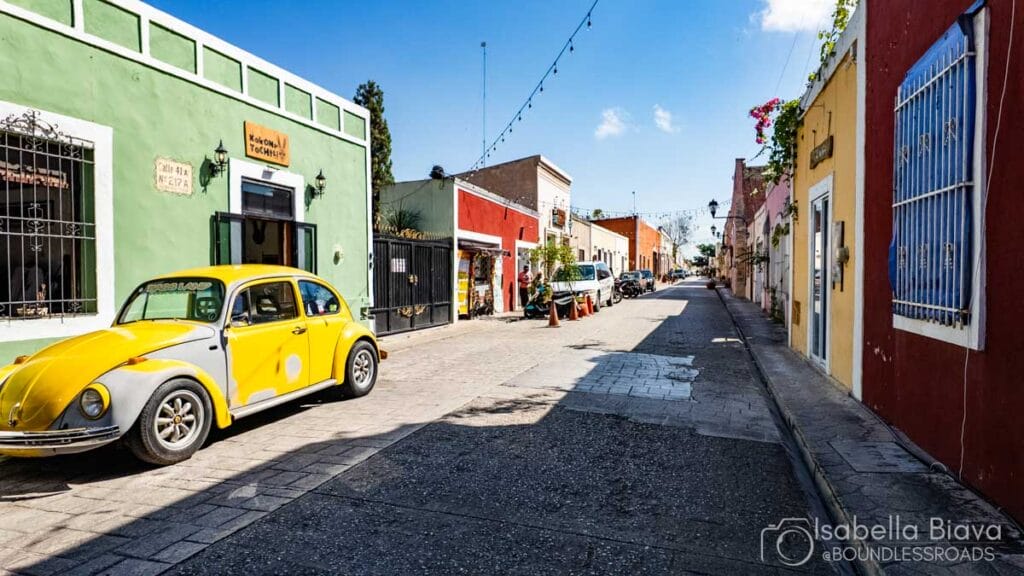 Colorful street with yellow Volkswagen Beetle